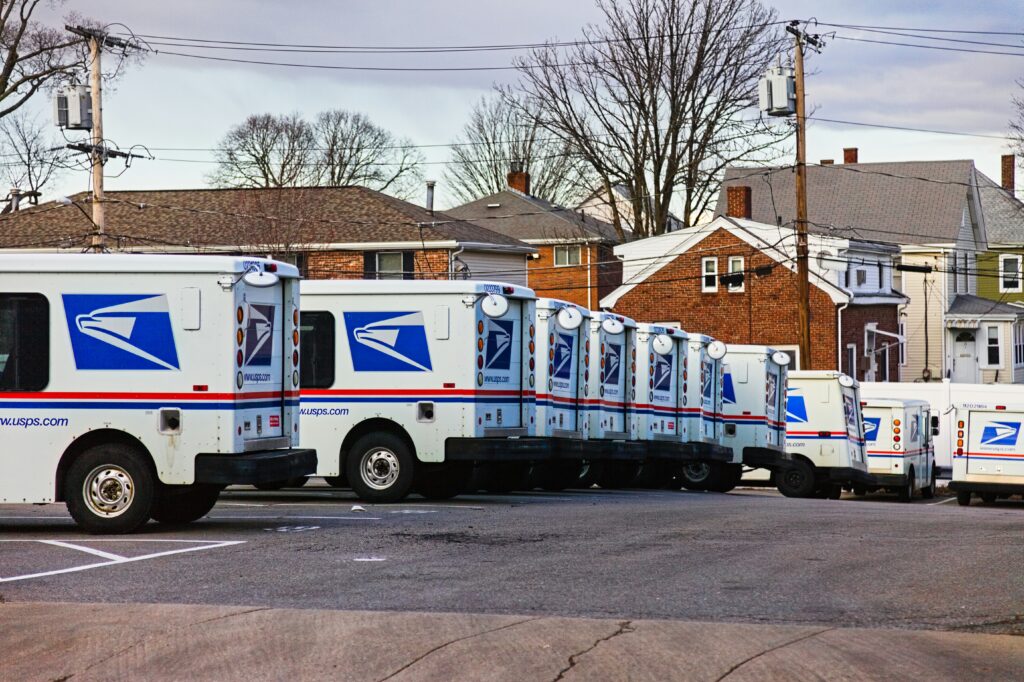 USPS mail trucks lines up in a row